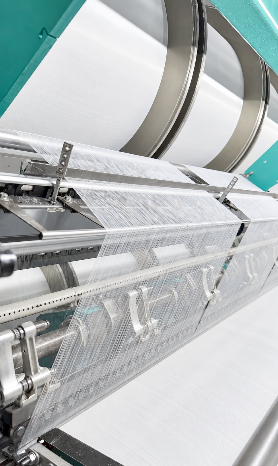 Parallel threads moving through textile production equipment in China
