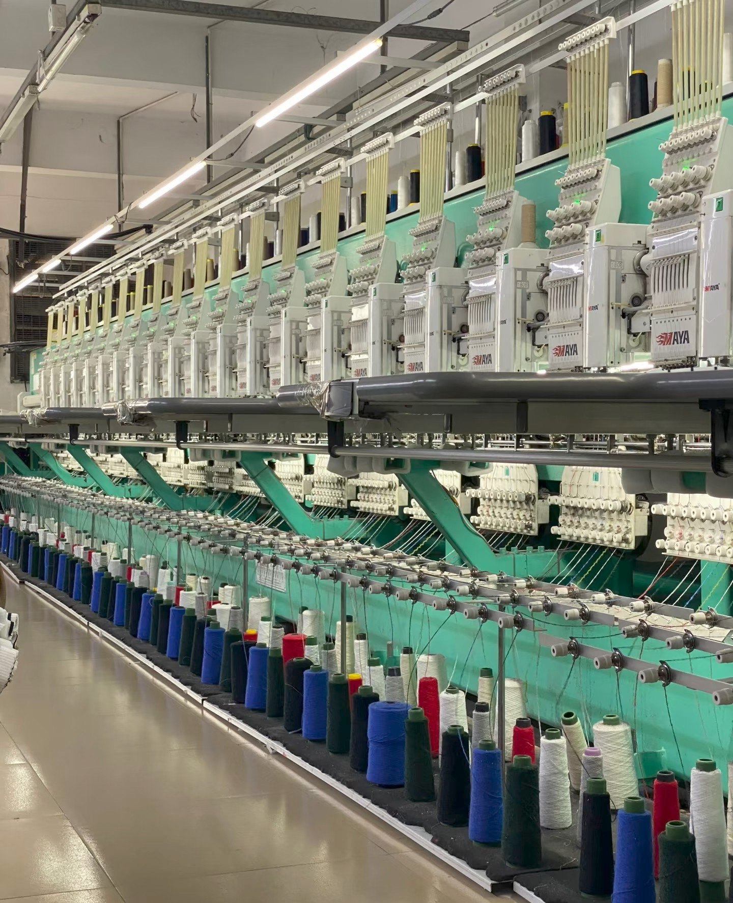 Industrial multi-head embroidery production line with thread cones